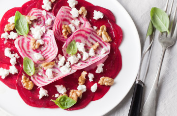 Raw beetroots carpaccio with goat cheese and walnuts